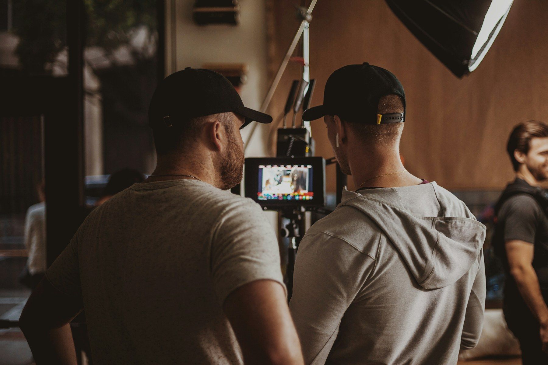 Film crew checking a shot on a monitor during a shoot