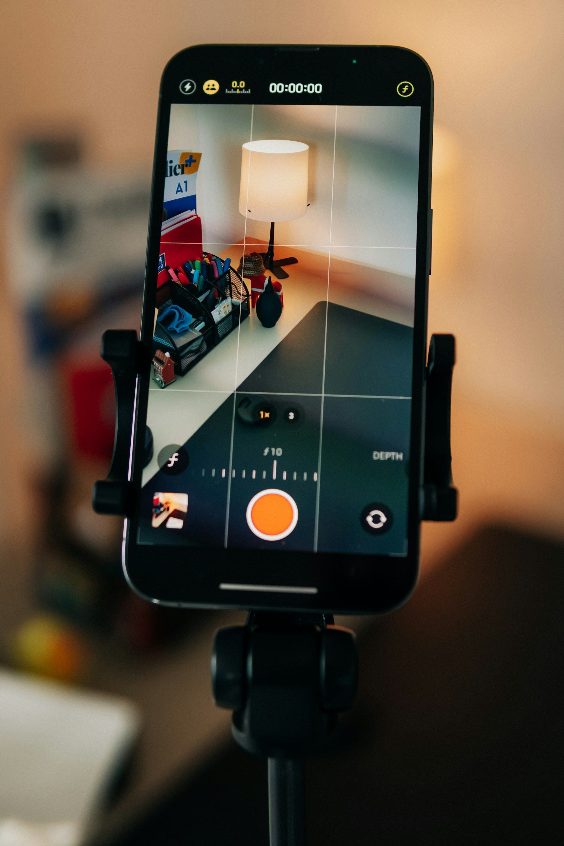 Smartphone on a tripod recording a desk scene